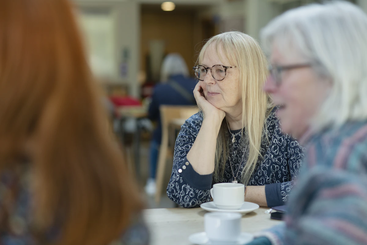 Women enjoying a conversation together over coffee